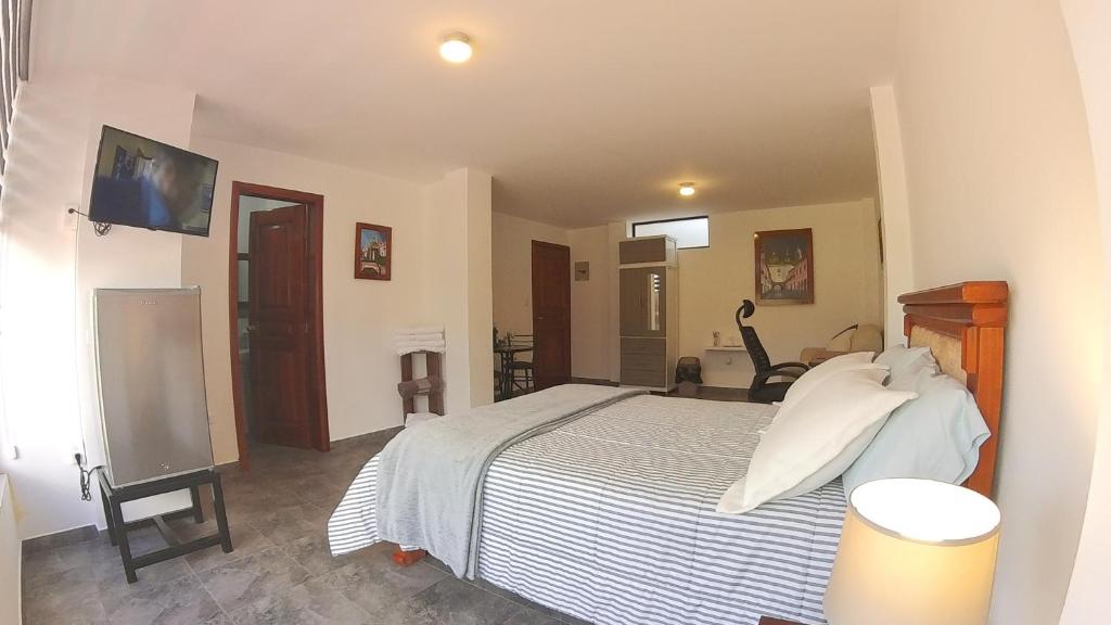 Postel nebo postele na pokoji v ubytování Hotel Suite Central Park Tababela