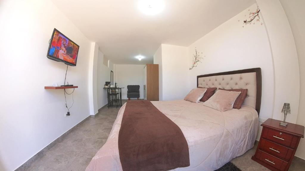 Postel nebo postele na pokoji v ubytování Hotel Suite Central Park Tababela