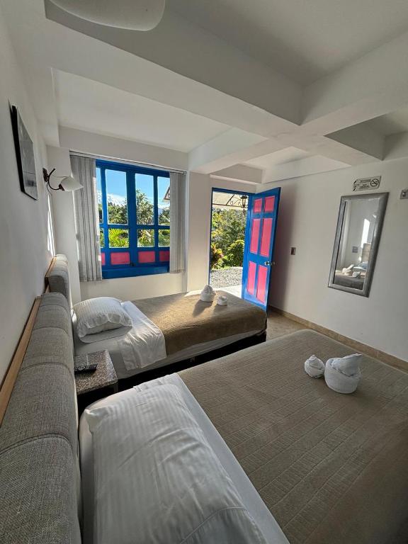 Postel nebo postele na pokoji v ubytování Hotel El Jardin