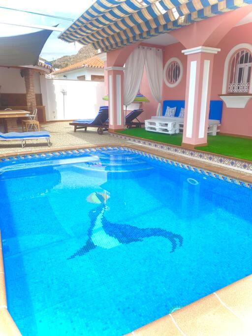 a woman swimming in a large swimming pool at Villa Ana Todo Confort in Alora