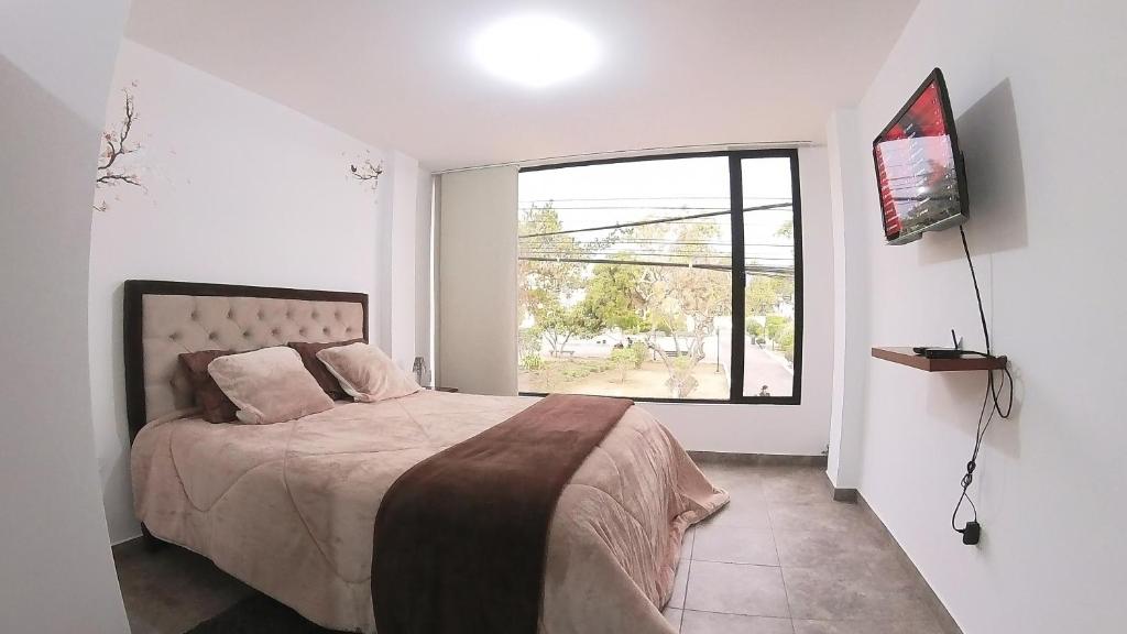Postel nebo postele na pokoji v ubytování Hotel Suite Central Park Tababela