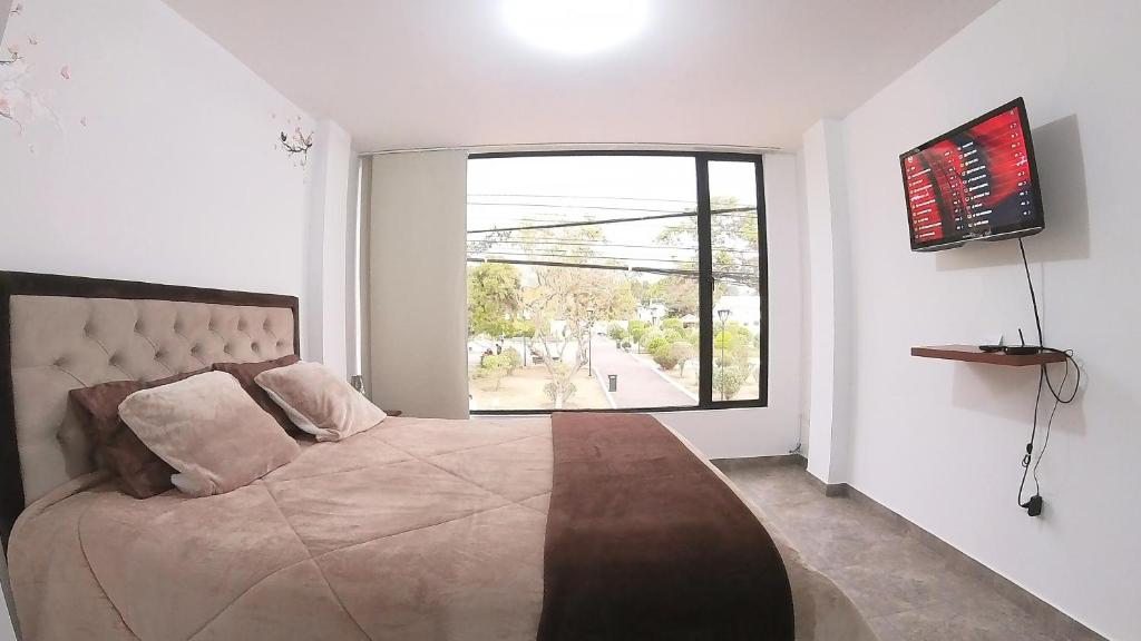Postel nebo postele na pokoji v ubytování Hotel Suite Central Park Tababela