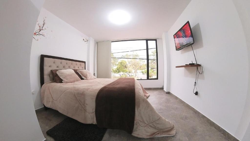 Postel nebo postele na pokoji v ubytování Hotel Suite Central Park Tababela