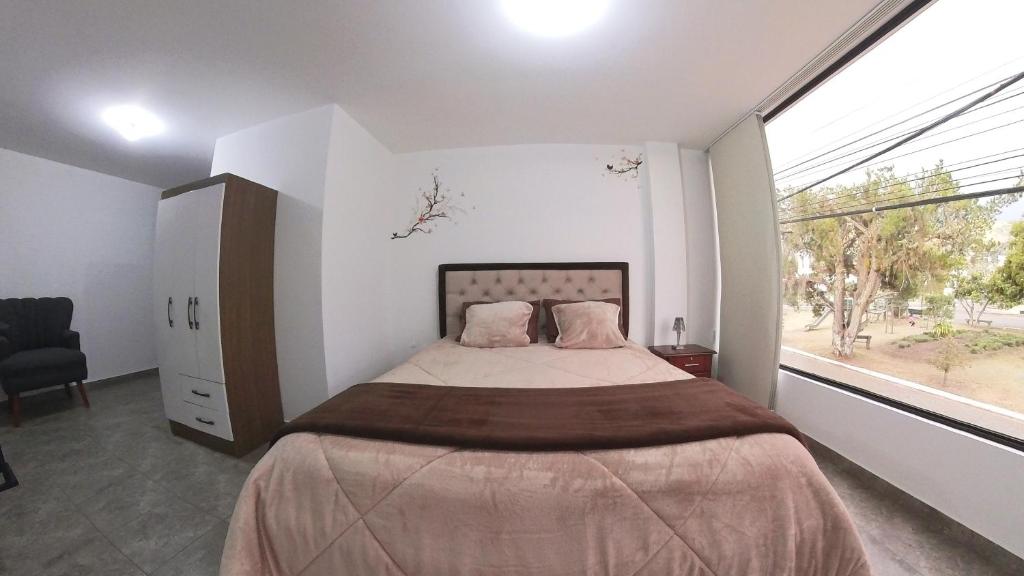 Postel nebo postele na pokoji v ubytování Hotel Suite Central Park Tababela