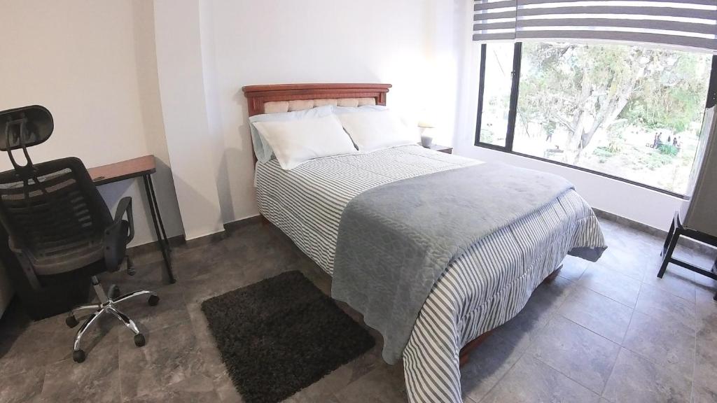 Postel nebo postele na pokoji v ubytování Hotel Suite Central Park Tababela