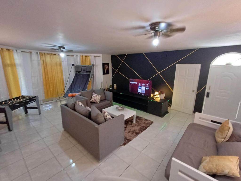 a living room with a couch and a slide at Linkzup Playa Laguna Villa in Sosúa