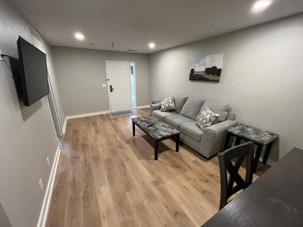 a living room with a couch and a table at Aksarben Apt-Cozy One Bedroom in Omaha