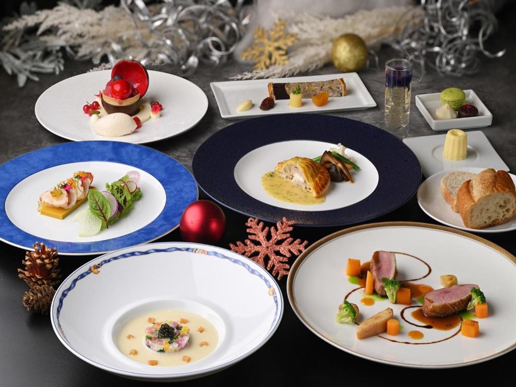 a table with plates of food on it at Lake Biwa Otsu Prince Hotel in Otsu