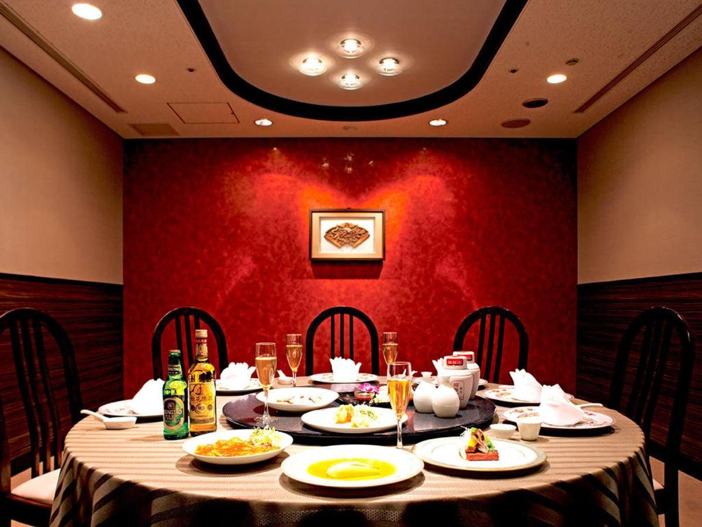 a table with plates of food on it in a restaurant at Lake Biwa Otsu Prince Hotel in Otsu