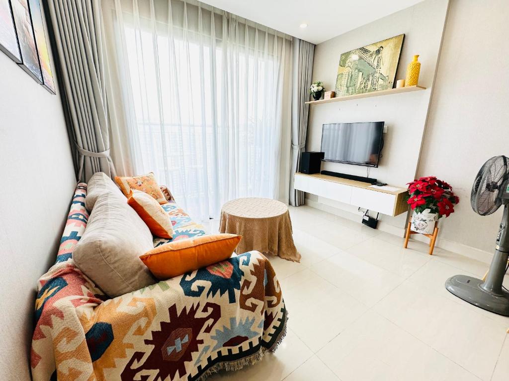 a living room with a couch and a television at OceanPark Amazing Cozy Modern great view 3Beds in Gia Lâm Pho