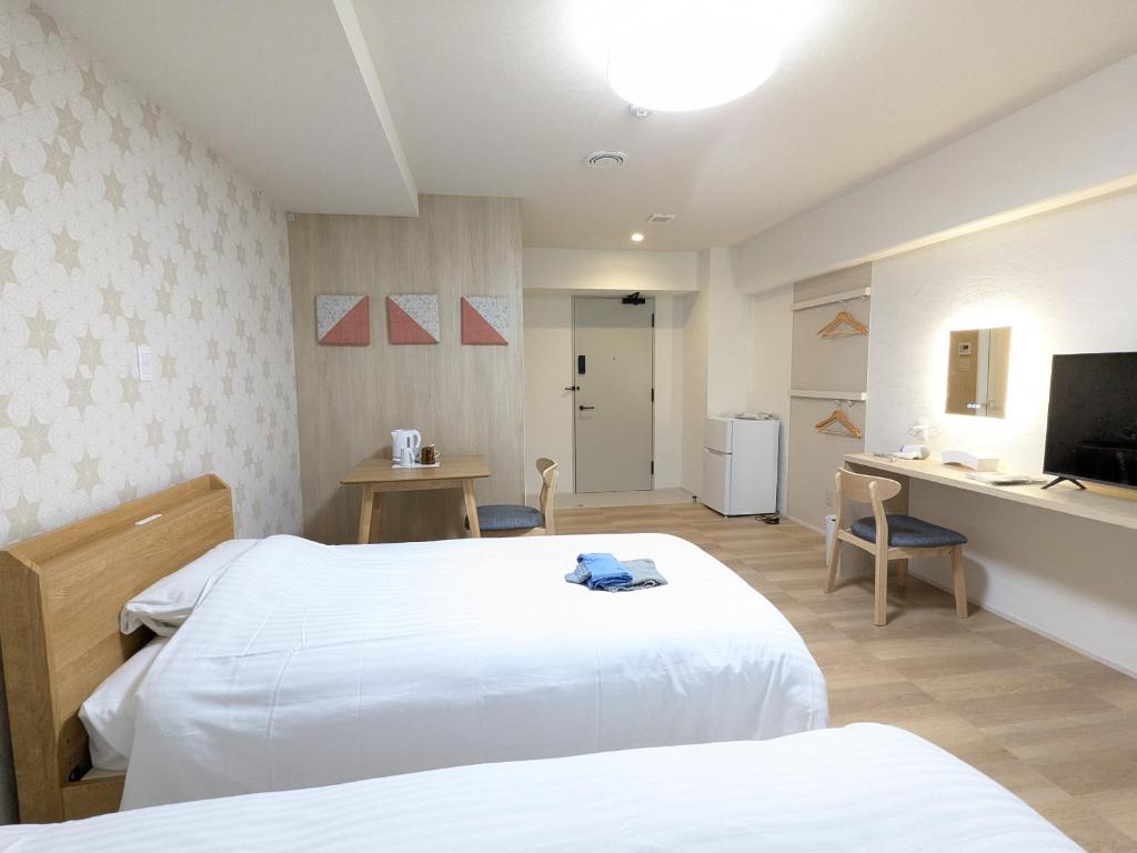TV a/nebo společenská místnost v ubytování Nikko Beans Hotel