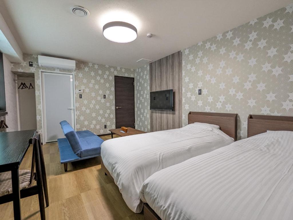 Postel nebo postele na pokoji v ubytování Nikko Beans Hotel