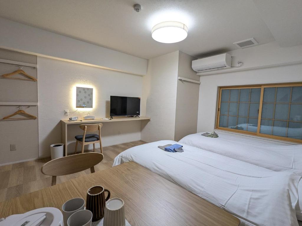 Postel nebo postele na pokoji v ubytování Nikko Beans Hotel