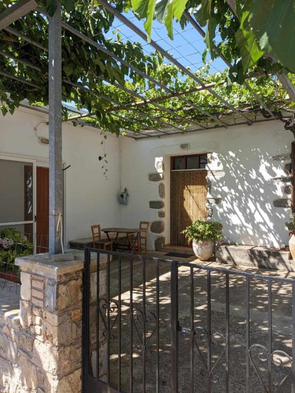 a house with a fence and a patio at house FYNTIKAKH - SKALA in Anopoli Sfakion