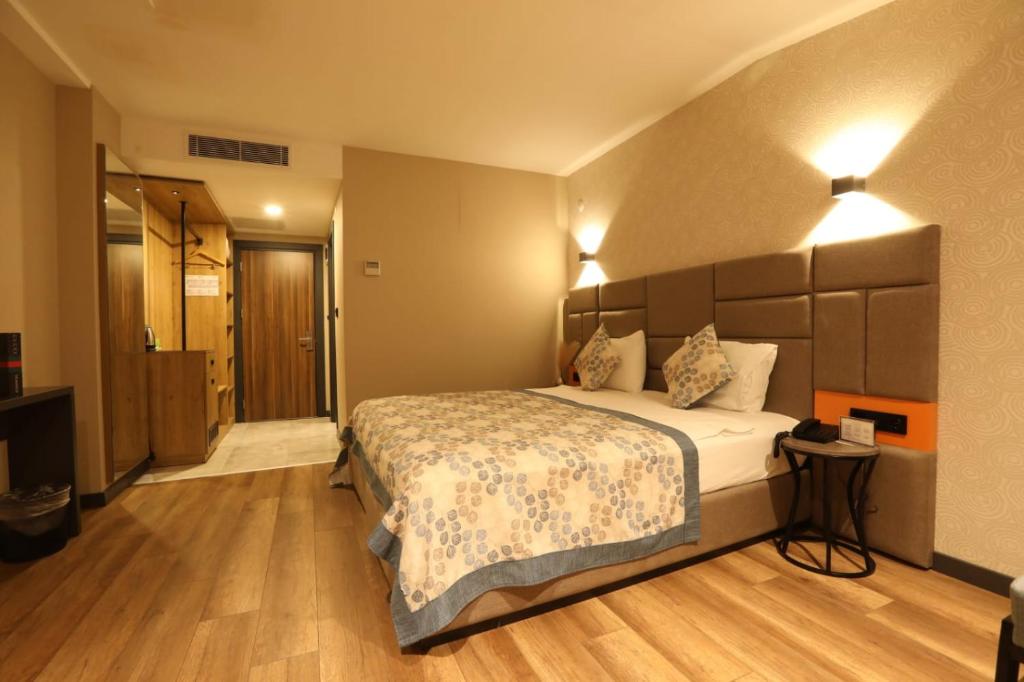 a hotel room with a bed and a hallway at İncipark Hotel in Sakarya