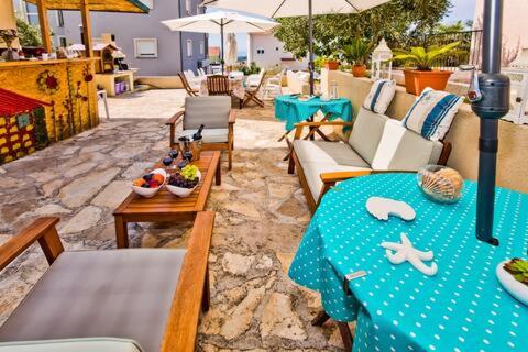 a patio with a table with a blue table cloth at Beautiful SeaView Villa in Hvar