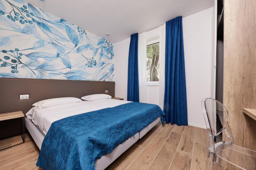 Postel nebo postele na pokoji v ubytování Hotel Catullo