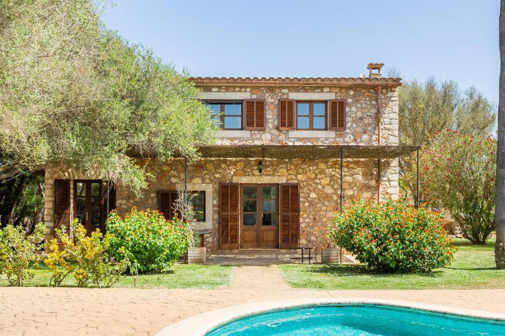 a stone house with a swimming pool in front of it at Mirabo ramonet in Caʼs Concos