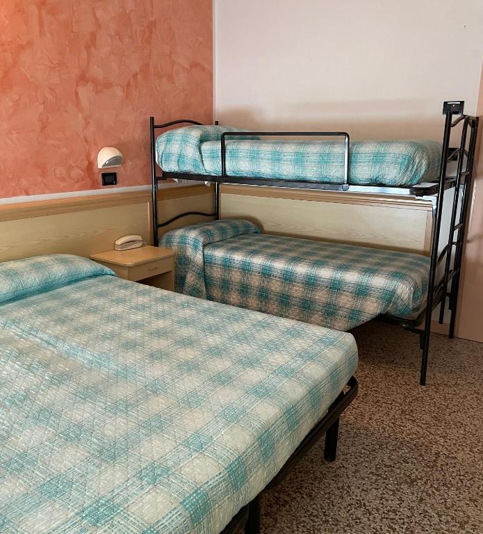 Postel nebo postele na pokoji v ubytování Piccolo Hotel