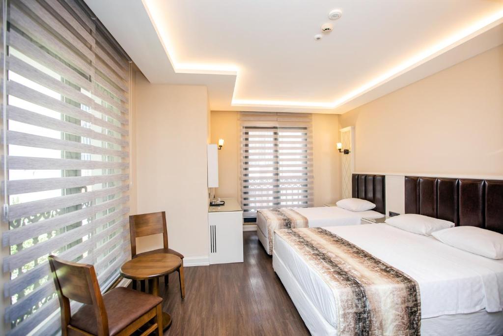 Postel nebo postele na pokoji v ubytování Opatija Hotel