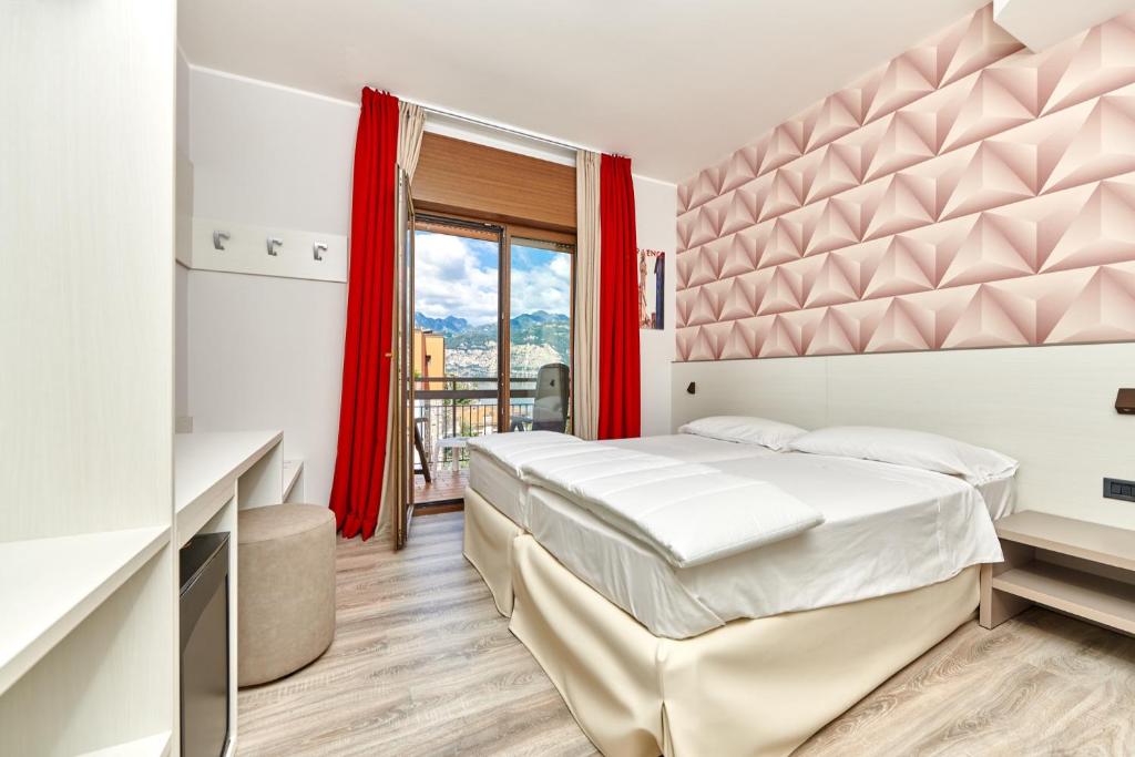 Postel nebo postele na pokoji v ubytování Hotel Catullo