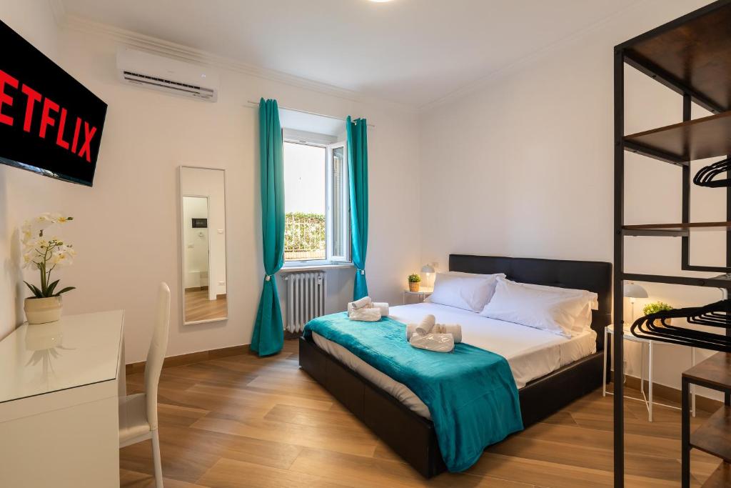 a bedroom with a bed with blue curtains and a window at Alba Vatican Apartment in Rome