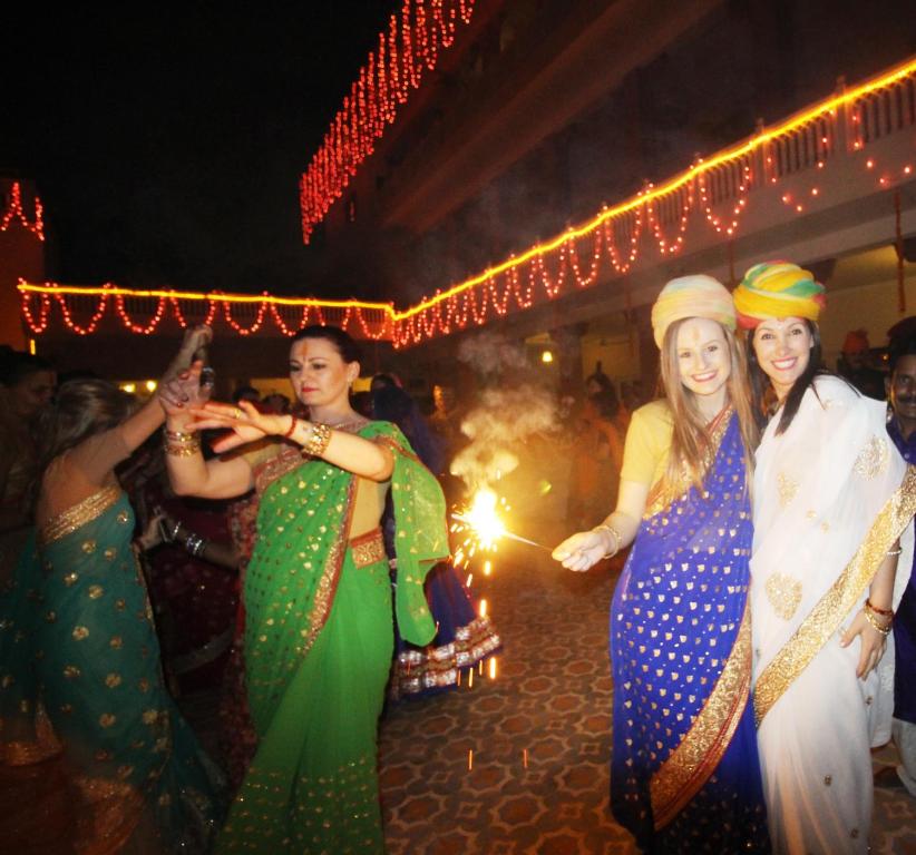 a group of women dancing at a party at Suryaa Villa - A Boutique Heritage Hotel in Jaipur