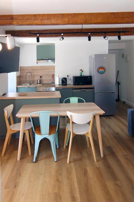 Il comprend une cuisine équipée d'une table et de chaises. dans l'établissement Caoubère, à Bagnères-de-Bigorre