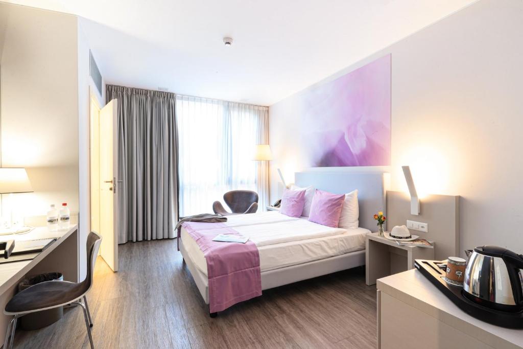 Postel nebo postele na pokoji v ubytování Hotel City Lugano