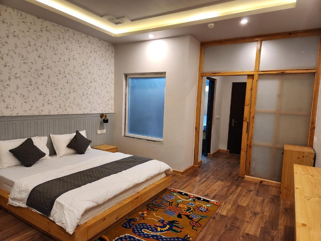 a bedroom with a large bed and a window at The Clove Ladakh in Leh