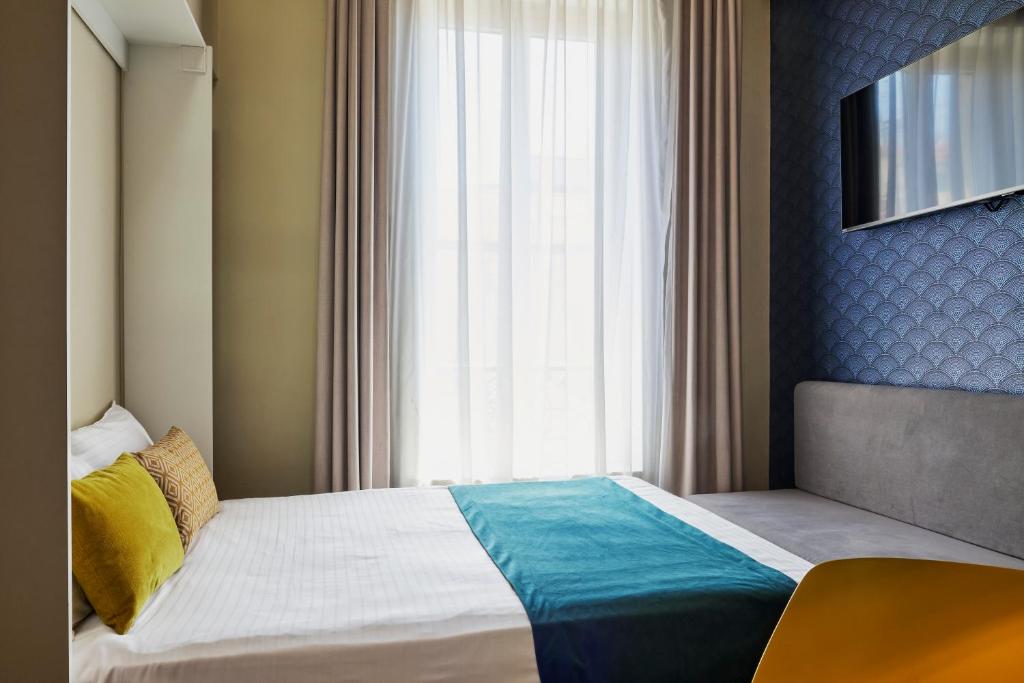 a bedroom with a bed with a large window at Hotel Nap By HappyCulture in Nice