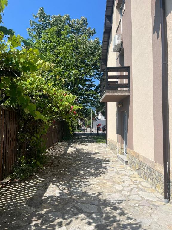 an empty alley between a building with a balcony at Big City House in Bihać