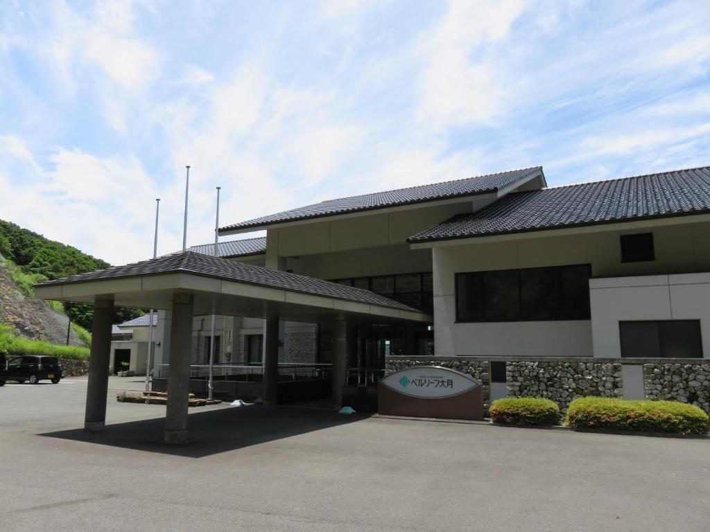 a building with a sign in front of it at Hotel Bellreaf Otsuki in Otsuki