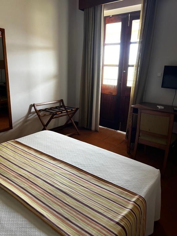 Postel nebo postele na pokoji v ubytování Bamboo Xaguate Hotel