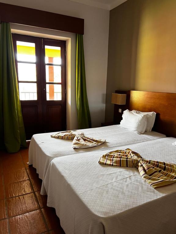 Postel nebo postele na pokoji v ubytování Bamboo Xaguate Hotel