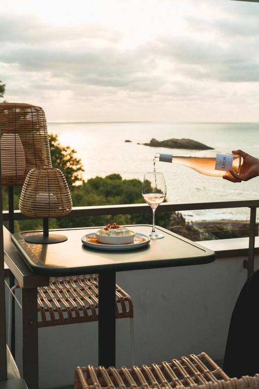 a glass of wine is being poured on a table at Hôtel de La Plage in Biarritz