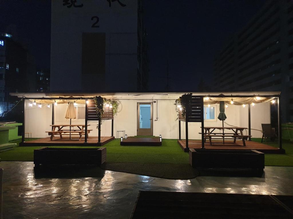 a small white building with lights on it at night at Cheongnyangni Star Whale House & Rooftop in Seoul