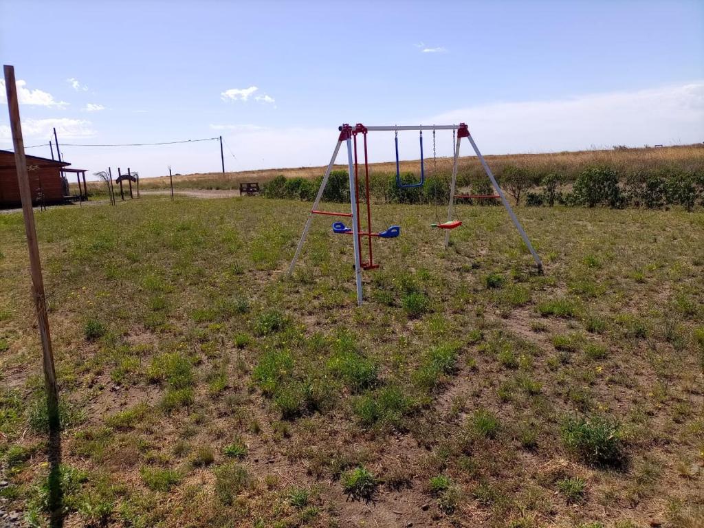 a swing set in the middle of a field at Cabañas Hakuna Matata in San Blás