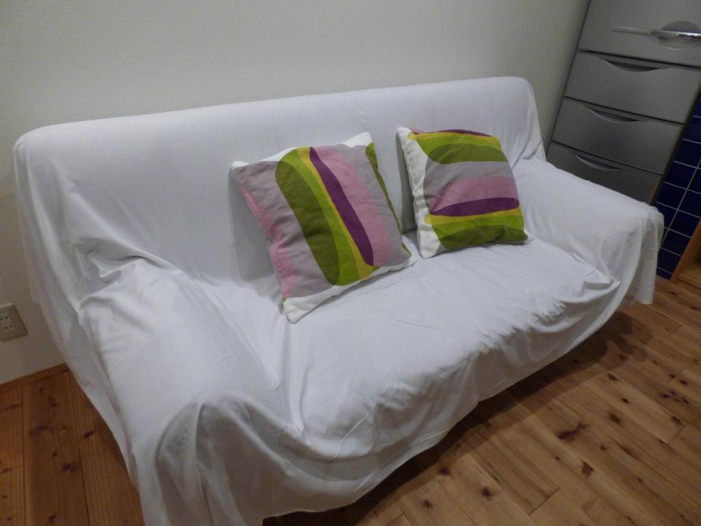 Postel nebo postele na pokoji v ubytování Guesthouse Hyakumanben Cross
