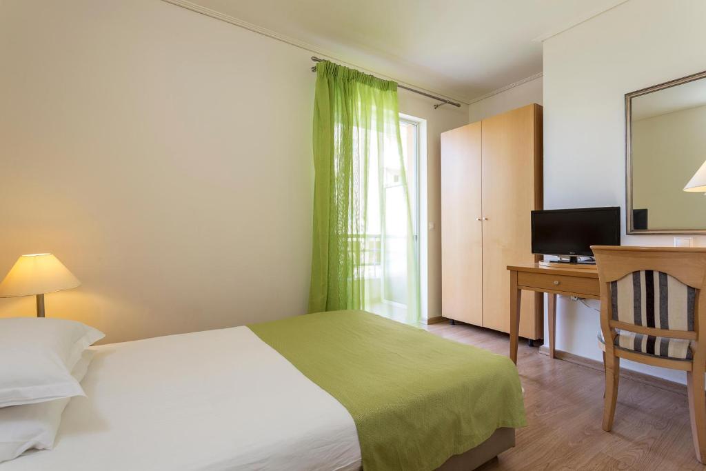 Postel nebo postele na pokoji v ubytování Civitel Attik Rooms & Suites