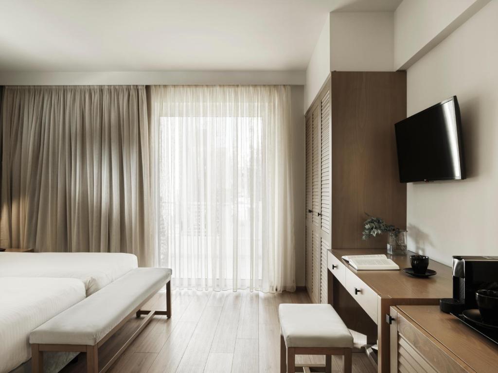 TV a/nebo společenská místnost v ubytování Civitel Attik Rooms & Suites