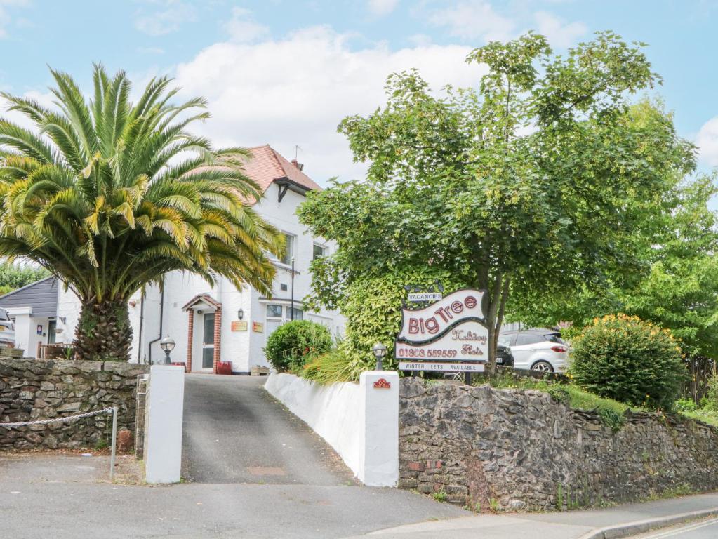 a house with a sign in front of a street at Flat 4, Big Tree Holiday Flats in Paignton