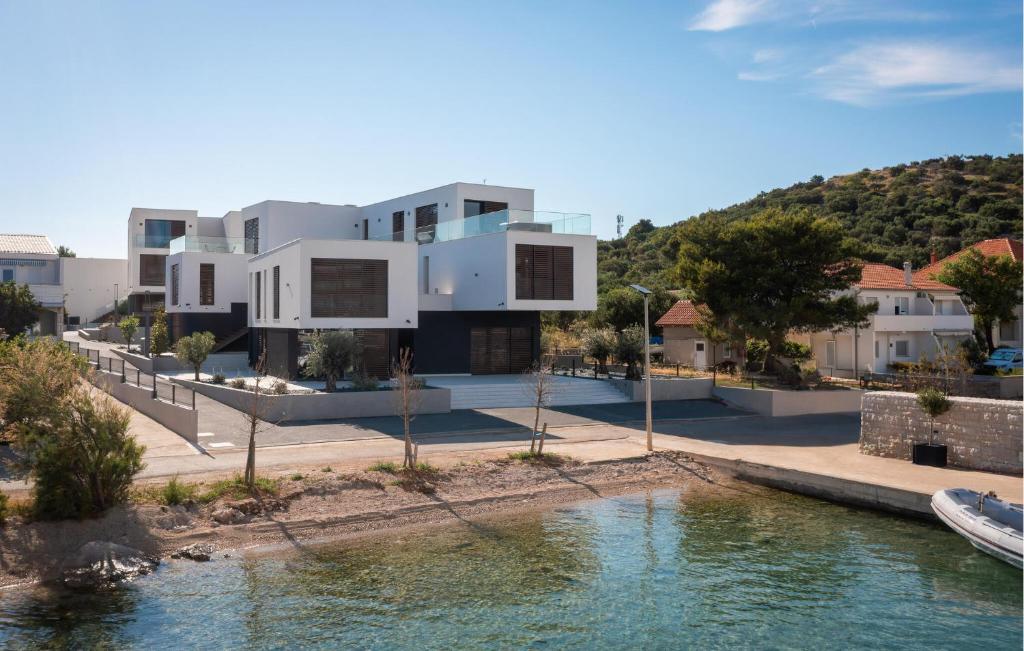 a house with a river in front of it at Gorgeous Apartment In Betina With Wifi in Betina