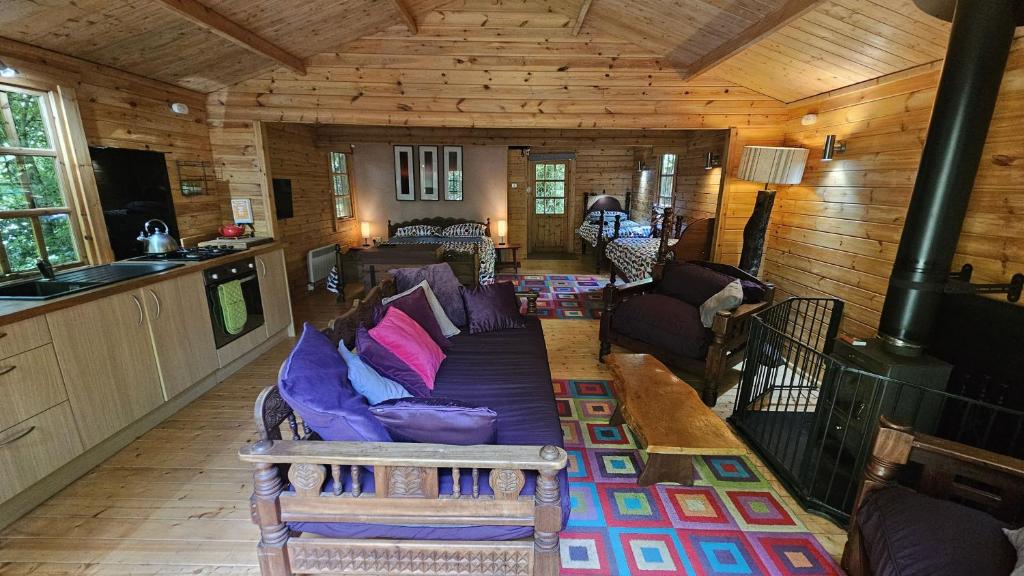 a living room with a couch in a cabin at Roseland Valley Retreat in Tregoney