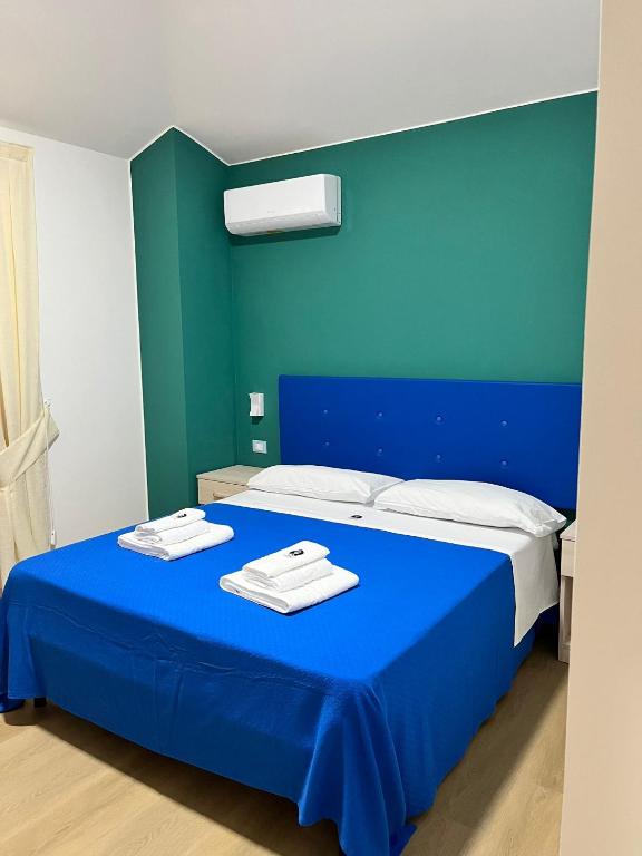 Postel nebo postele na pokoji v ubytování La Terrazza degli Dei
