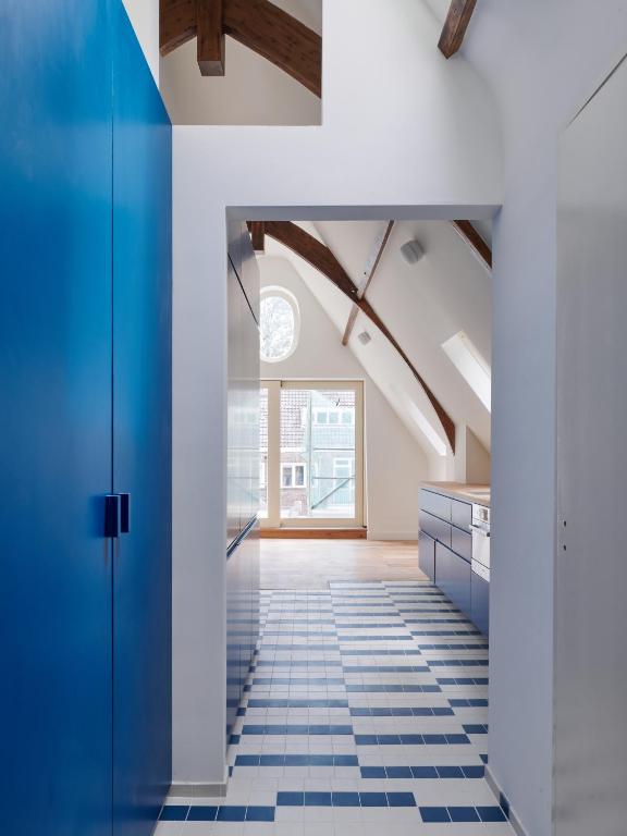 a room with a blue door and a tile floor at Central Art Apartment - Nieuwmarkt area in Amsterdam