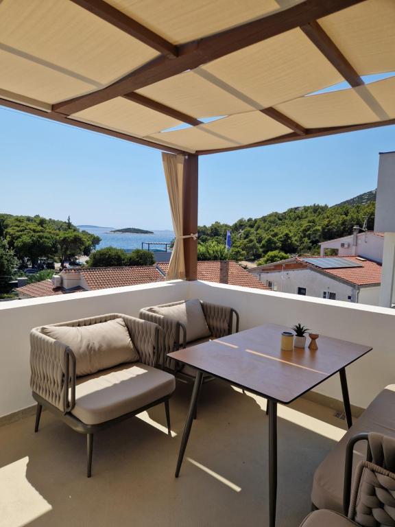a living room with a table and a couch at Maris i Maksim in Tribunj