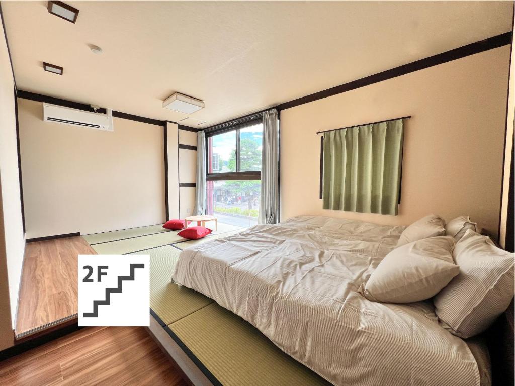 Postel nebo postele na pokoji v ubytování Jinya Sunset Inn by Murasaki