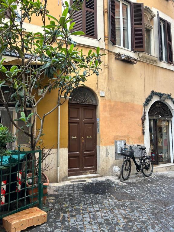 a bike parked in front of a building with a door at Navona Suite Rome - quite and view in Rome