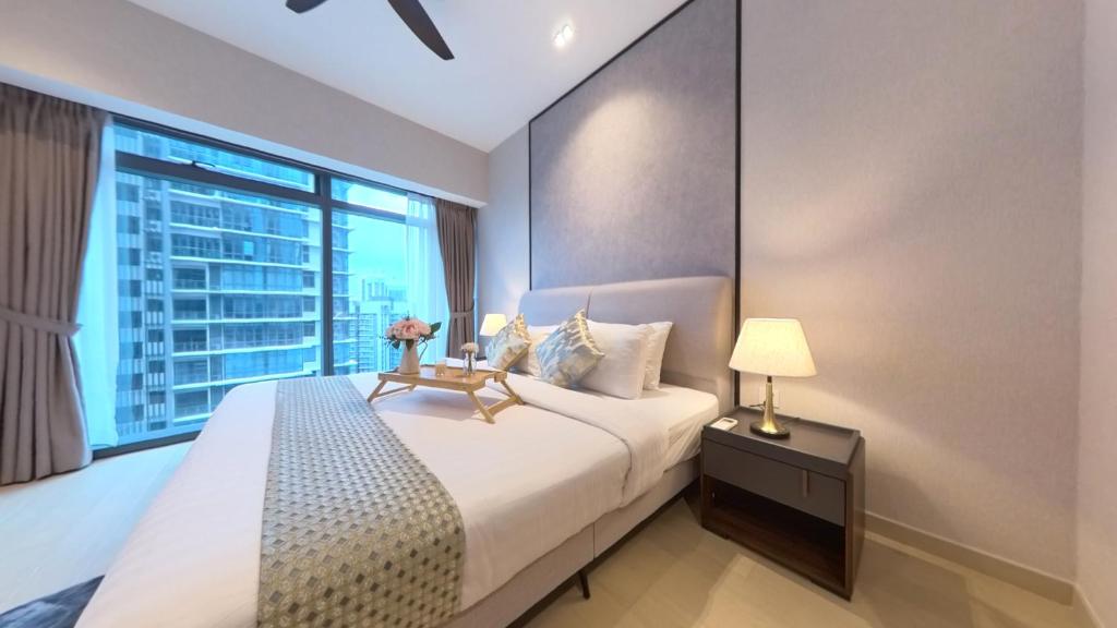 a bedroom with a large bed and a large window at Eaton Residence KLCC - JD HOME in Kuala Lumpur